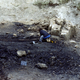 A woman digs on an archaeological site in Italy.